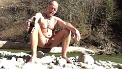 nudist daddy playing with his dick in the great outdoors Thumb